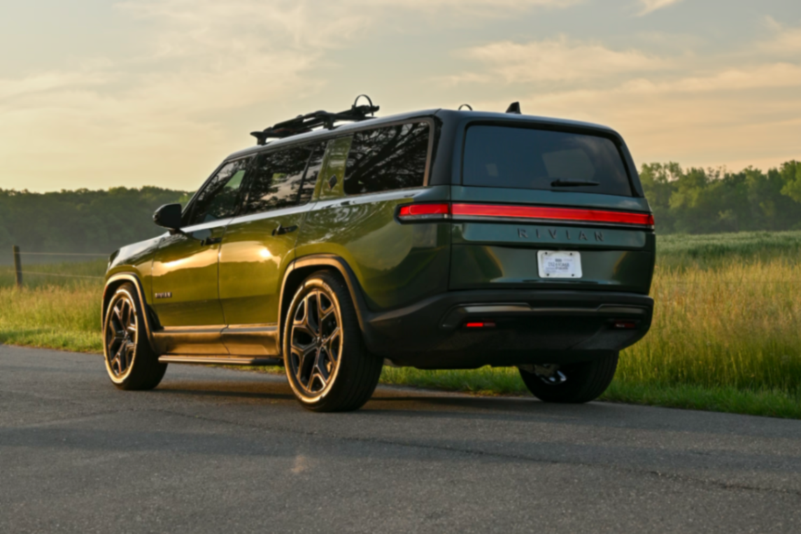Green Rivian R1S at sunset